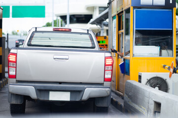 The car pays the cashier for the entrance to the motorway toll gate