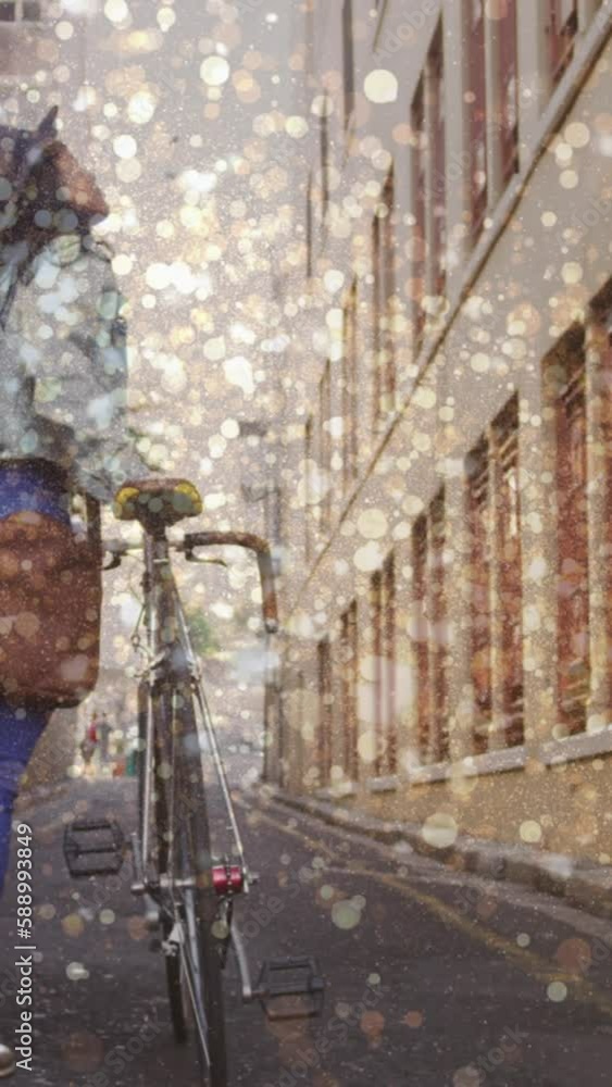 Wall mural Animation of light spots over biracial woman walking with bicycle