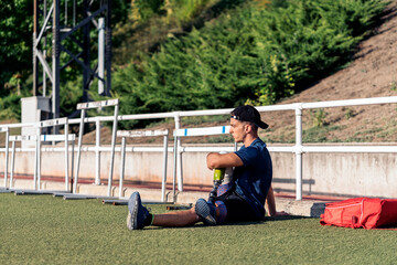 Disabled man athlete stretching with leg prosthesis.