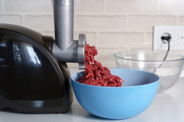 Grinder for preparation of minced meat in kitchen, domestic kitchen, selective focus