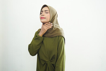 Asian Muslim woman feels so thirsty because of the hot weather during the summer season while...