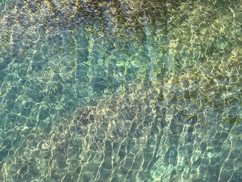 Beautiful sea water with glittering clear light turquoise surface.