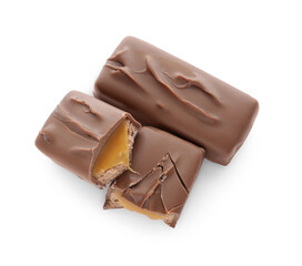 Pieces of chocolate bars with caramel on white background, top view