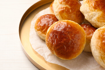 Plate with freshly baked soda water scones on white wooden table, closeup