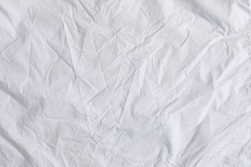 Fototapeta premium Crumpled white fabric as background, top view
