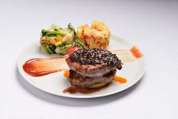 Filet mignon with cranberry sauce, potato salad and steamed mixed vegetable salad.