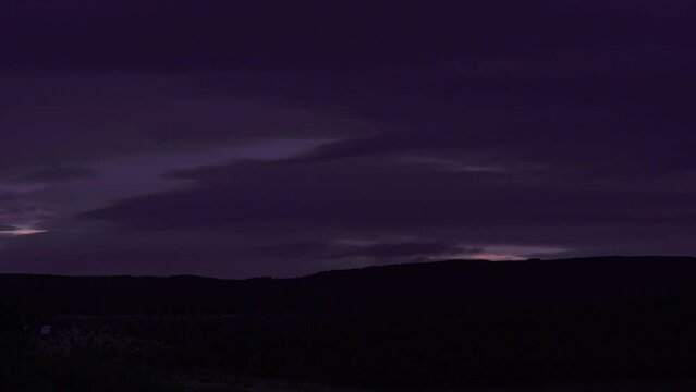 Time lapse shot of a sunset over the countryside. Farm land is visible in the foreground. Shot on the Isle of Lewis, part of the Outer Hebrides of Scotland.
