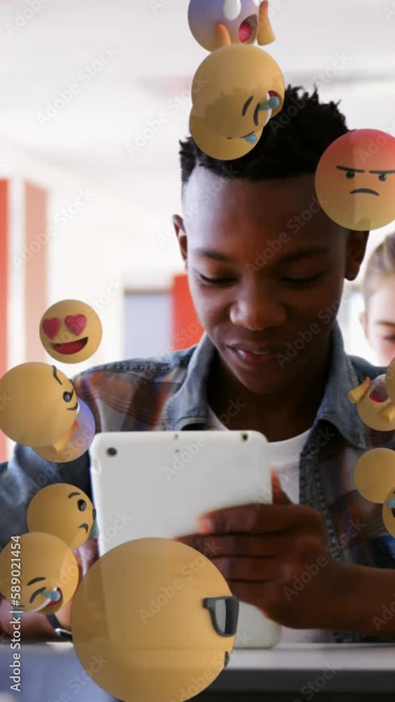 Poster animation of emoticons over diverse students in class using tablets