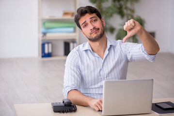 Young male employee working in the office