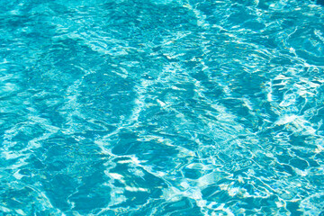 Fototapeta na wymiar Ripple Water in swimming pool with sun reflection. Wavy water background.