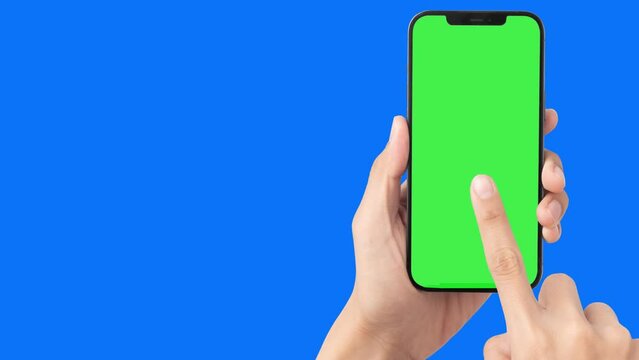 Man Hand Holding Smartphone (with Green Screen) And Clicking With His Finger (pointer) In Touchscreen. Mobile Phone Mockup. Chroma Key Background With Copy Space. 4k Video 