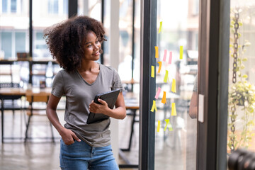happy asian female looking at memos, student looking at her project plan work in paper