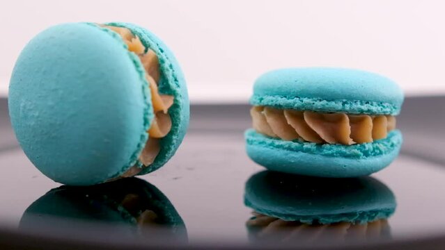Man takes one macaroon or macaron in a pile of almond cookies. High quality FullHD footage
