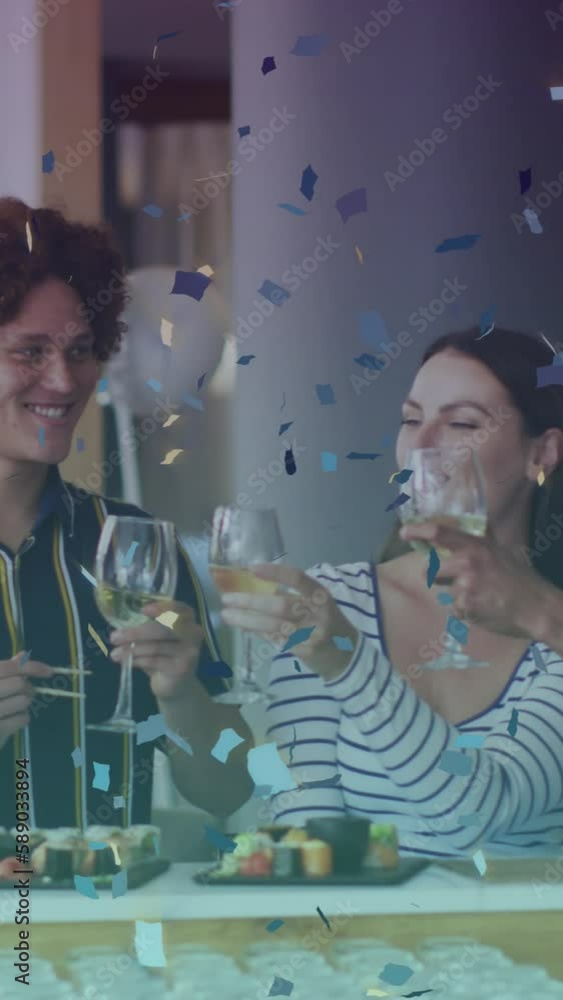 Sticker Animation of glass icon and confetti over happy diverse friends eating sushi and drinking wine