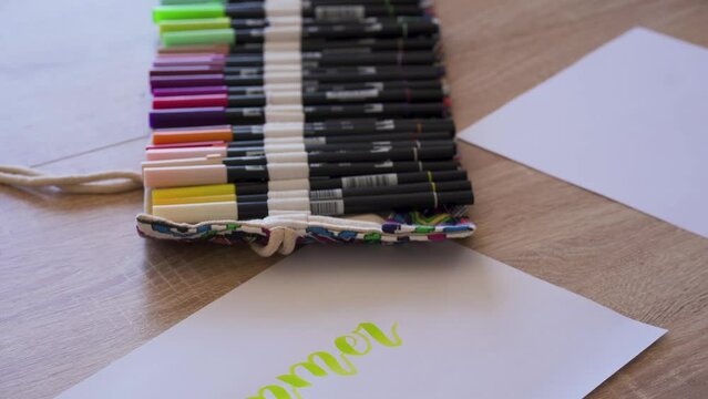 Woman making handwriting calligraphy, lettering summer word