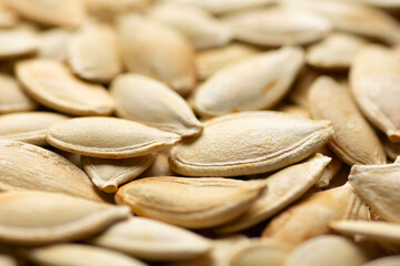 detail of pumpkin seeds background with selective focus