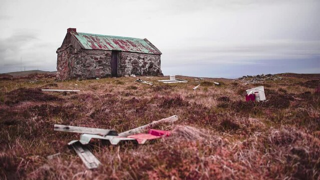 Time lapse shot of the clouds passing over a remote, ruined moorland shieling at sunset. Filmed in summer on the Isle of Lewis, part of the Outer Hebrides of Scotland.
