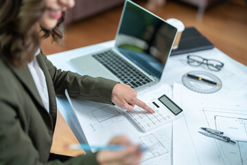 Portrait of young female architect working on project