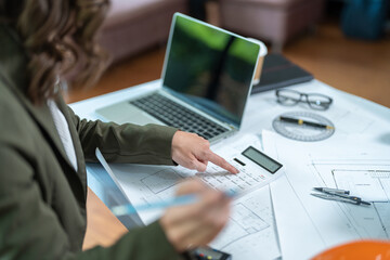 Fototapeta premium Portrait of young female architect working on project