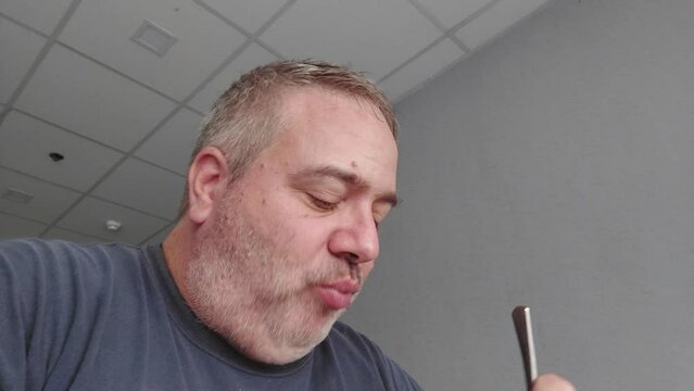 A caucasian man eating
