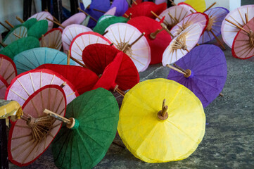 Multi colored mulberry paper umbrellas on the floor
