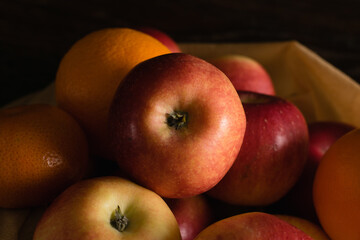 Fruit in a reusable bag. Earth day and zero waste concept. Apples close-up on a dark background