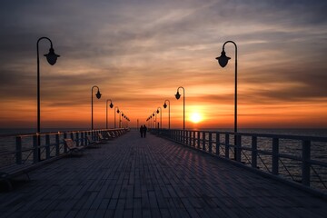 Beautiful sunrise over the Polish sea. Popular pier on the Baltic Sea at sunrise. Photo taken in Gdynia, Poland.