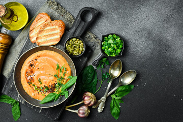 Carrot cream soup with basil and cream. In a bowl. Healthy food concept. Close up.