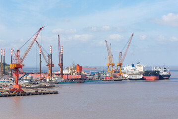 Shipyard, panorama view on the dockyard with cranes and ships.