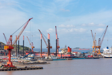 Fototapeta na wymiar Shipyard, panorama view on the dockyard with cranes and ships.