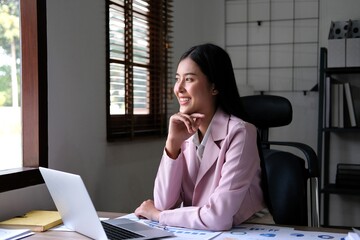 Young asian girl working at the office with laptop and calculator thinking looking tired and bored with depression problems