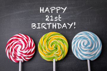 Happy 21st birthday. Colorful lollipop on a black chalkboard background