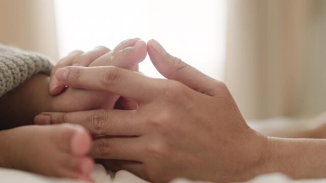 Mom and her Child,mom day,Happy asian Family and mother day concept.Beautiful conceptual image of Maternity.Newborn or Baby feet in mother hands.