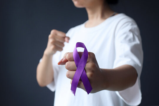 International Epilepsy Day. Cropped shot of body fight cancer, purple ribbon on fist hand. Alzheimer's disease, Pancreatic cancer, Hodgkin's Lymphoma awareness