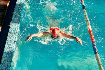 Swimming - male swimmer swimming breaststroke. Close up portrait of man doing breast stroke...