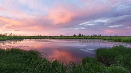 Foto op Canvas Colorful sunset over swamp and forest: reflection of clouds, nature of Northern Europe, summer evening. © ROMAN BELIAKOV