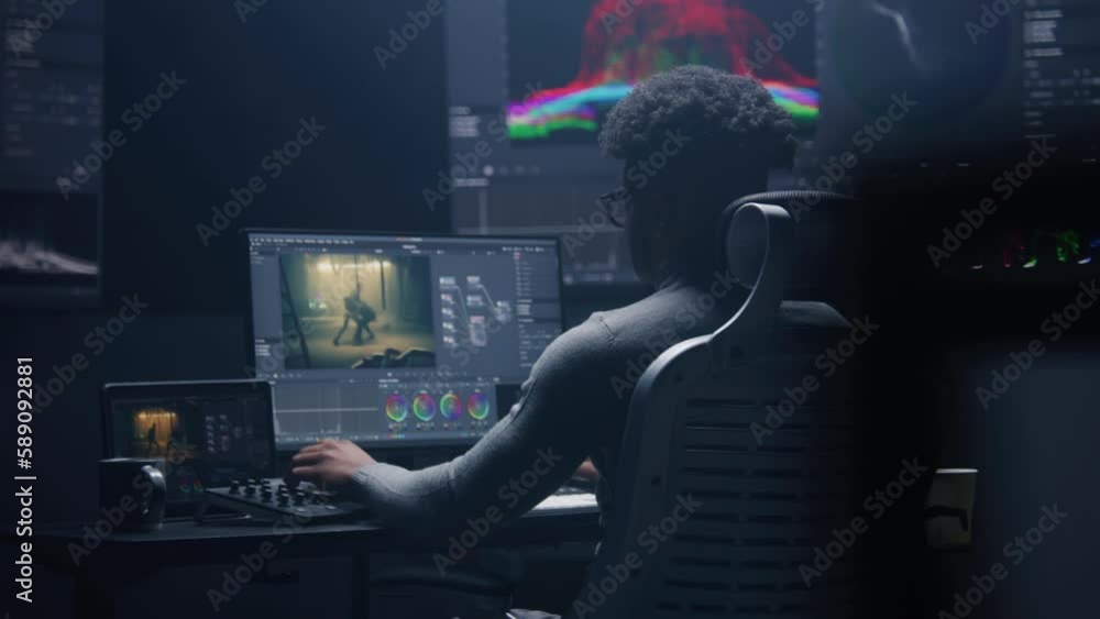 Poster african american film editor does color grading on computer in modern studio. big monitors with rgb 