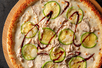 Closeup on chicken pizza with zucchini and balsamic sauce