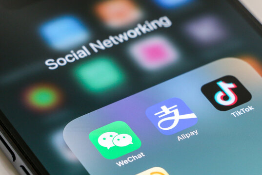 Popular Chinese social media apps, WeChat, Alipay, Tik Tok and Weibo app icons displayed on smartphone screen. Social networking concept.