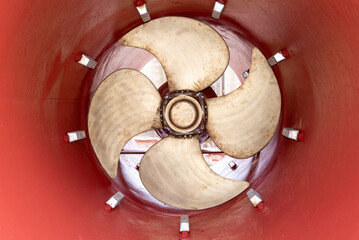 View on the stern thruster propeller of the big container ship. Ship is in the dry dock for...