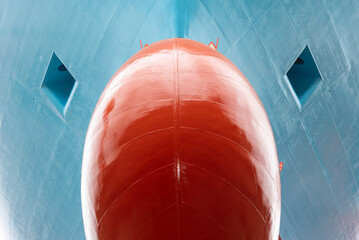 Close up view on the newly painted bulbous bow of big container ship. Ship in dry dock for...