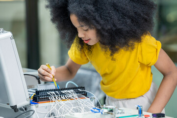 Girl female teen children concentrate enjoy Machine Learning Robot is Moving Under Control robot coding at technology stem class, stem education robot for digital automation artificial intelligence ai © BESTIMAGE