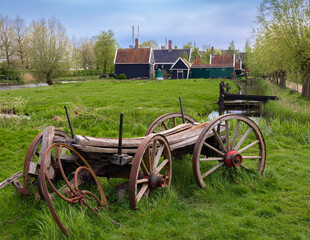 A beautiful rural landscape in Hollands Zaanse Schans, featuring a wooden cart and building...
