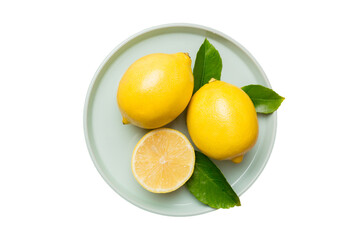 Fresh cutted lemon and whole lemons over round plate isolated on white background. Food and drink ingredients preparing. healthy eating theme top view with copy space