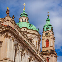 Fototapeta premium Baroque art and architecture in Prague. Church of Saint Nicholas beautiful dome and clock tower erected in 18th centuty in Mala Strana district