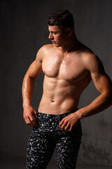 Fototapeta premium A guy in a great sports uniform in the studio on a gray background.