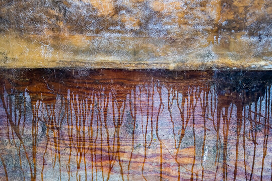 Dripping paint rivulets on repaired fiberglass, mottled and striped colours.