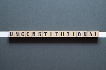 Unconstitutional - word concept on cubes
