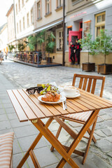 A croissant and a cup of coffee on the cafe's summer terrace
