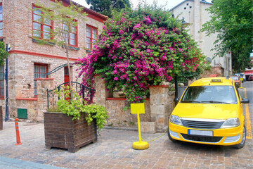 Yellow taxi on a street corner in the old district of Antalya.
